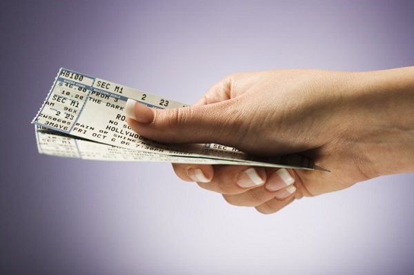 Woman holding concert tickets