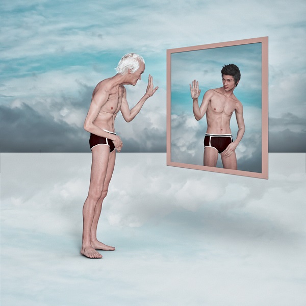 Older man admiring image of younger man in virtual mirror