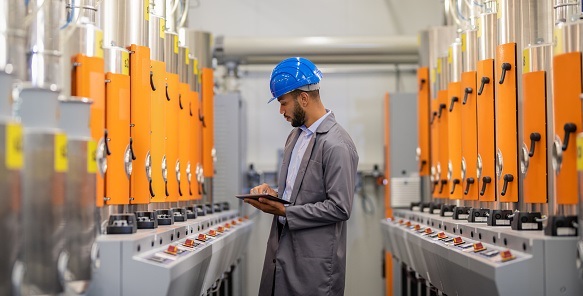 Engineer Inspecting Factory Machinery