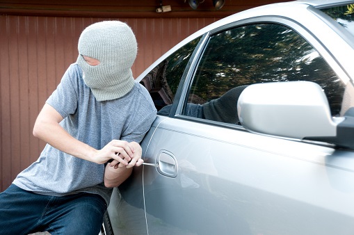 Grey masked teenager breaking into a car Car Parts Thefts and AI Autonomous Cars 1