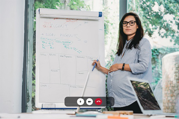 Screenshot of a pregnant young woman having a video call with colleagues