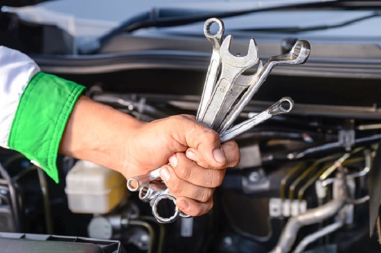 metallic wrench is in a hand