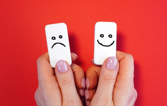 Good mood and bad mood concept with blocks and smiles in a hands