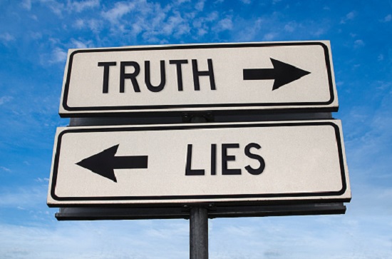 Truth vs lies. White two street signs with arrow on metal pole with word