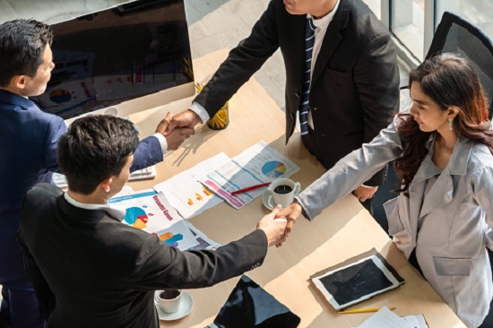 Group business people handshake at meeting table